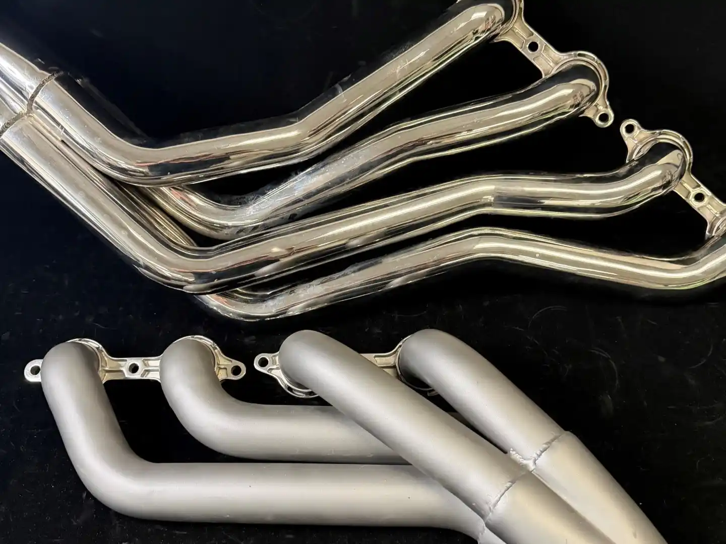 Custom stainless steel engine swap headers installed in a high-performance street rod chassis.